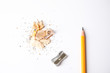 Pencil, sharpener and shavings on white background, top view