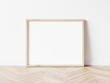 © Washdog - Horizontall wood frame mock up. Wooden frame poster on wooden floor with white wall. Landscape frame 3d illustrations.