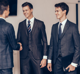 Wall Mural - handshake business partners in the meeting room of the business center