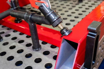 Poster - metal structures are fixed on the table. assembly table. table for installation work. work with meta