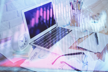 Stock market chart hologram drawn on personal computer background. Double exposure. Concept of investment.