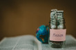 © Jantanee - Savings jars full of money for mission, christian concept.