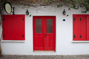 Exterior of authentic houses and colorful wooden shutters in Sigacik village, Izmir city, Turkey.