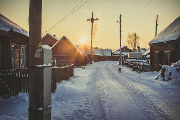  Siberian village in winter at sunset