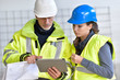 © goodluz - Instructor with apprentice on construction site working with tablet