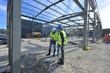 © goodluz - Engineering instructor working on building site with apprentice