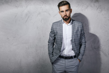 Wall Mural - Handsome bearded man wearing gray checkered suit