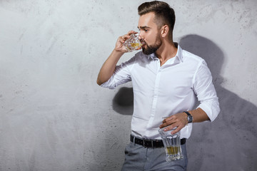 Wall Mural - Handsome bearded man with a glass of whiskey