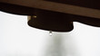 Single clear rain water drop hanging from the edge of a roof