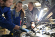 © goodluz - Instructor with trainees working on car engine
