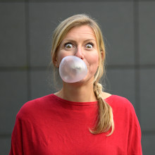 Blond Woman Having Fun With Bubblegum