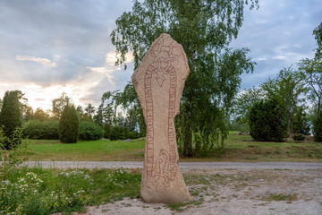 Canvas Print - Large and tall rune stone with runes in the shape of a long red snake