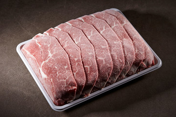 Frozen shabu shabu meat on black background