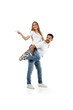 © producer - man carrying young woman on his back. boyfriend giving piggyback to girlfriend on white background