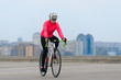 © Maksym Protsenko - Young Woman Riding Road Bicycle on Free Street in the City. Healthy Lifestyle and Sport Concept.