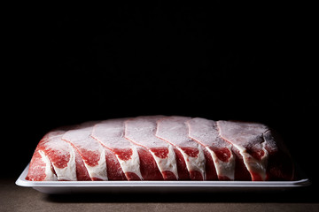 Canvas Print - Frozen shabu shabu meat on black background