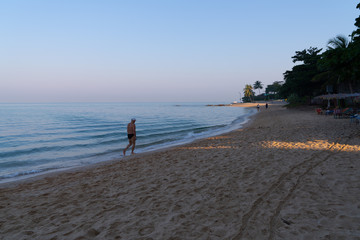 Poster - couple walking on beach at sunset