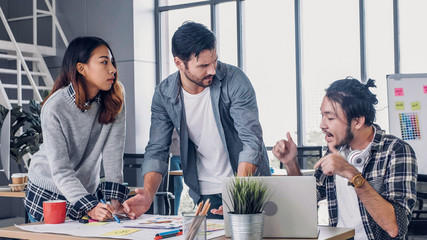 creative designer team argument at casual meeting table and walk out from meeting in modern office.t