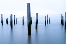 Poles At The Sea During Blue Hour