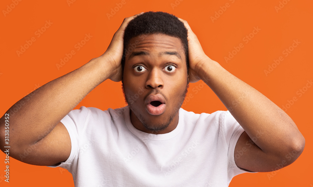 Surprised black man clutched his head in his hands Stock Photo | Adobe ...