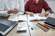 © Thitiphat - Teaching helping and study course, Team of young teacher or tutor helps students to learning in classroom for homework a test or exam at desk with papers
