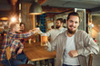 © Studio Romantic - Group of male friends drink beer at a party in a bar.