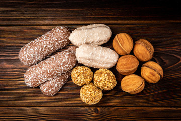 Wall Mural - Different types of cookies on dark wooden background.