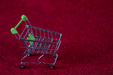 Red background and shopping trolley Shopping concept and trading