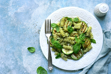 Wall Mural - Spring fusilli pasta with pesto sauce and zucchini. Top view with copy space.