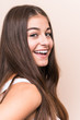 © Asier - Young cute caucasian woman against a beige background