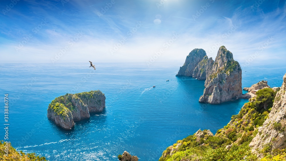 Famous Faraglioni Rocks near Capri Island, Italy. Beautiful paradise landscape with azure sea in summer sunny day. - obrazy, fototapety, plakaty 