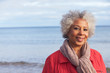 © Monkey Business - Head And Shoulders Portrait Of Active Senior Woman Walking Along Winter Beach With Sea Behind