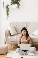 Poster - Working from home. Young freelancer sitting on floor with laptop