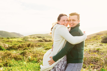 Wall Mural - sincere smiles and embraces of the guy and the girl on the backg