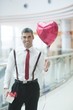 © moodboard - Businessman holding heart shaped balloon and present