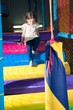 © moodboard - Young girl climbing down play gym