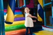 © moodboard - Young girl hitting foam object in play gym