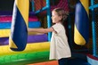 © moodboard - Young girl hitting foam object in play gym
