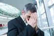 © moodboard - Disappointed businessman with head in hands