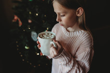 Girl Holding Mug Of Marshmallow In Hot Chocolate Drink