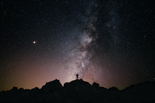 Panoramic of a person looking at the milky way