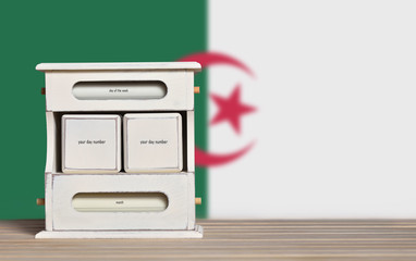 Fototapete - Wooden retro calendar with free space for a date on the background of the flag of Algeria. Template for writing the dates of the national holidays of Algeria with free text space