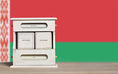 Fototapete - Wooden retro calendar with free space for a date on the background of the flag of Belarus. Template for writing the dates of the national holidays of Belarus with free text space