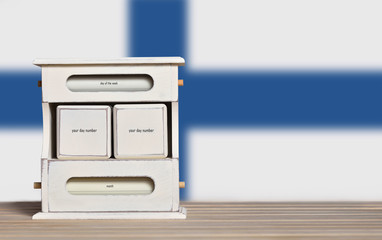 Fototapete - Wooden retro calendar with free space for a date on the background of the flag of Finland. Template for writing the dates of the national holidays of Finland with free text space