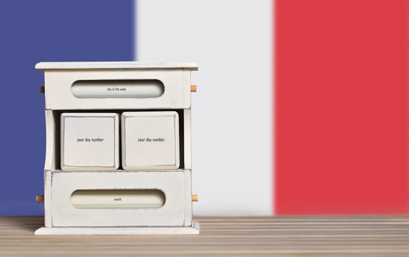 Wooden retro calendar with free space for a date on the background of the flag of France. Template for writing the dates of the national holidays of France with free text space