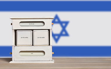 Fototapete - Wooden retro calendar with free space for a date on the background of the flag of Israel. Template for writing the dates of the national holidays of Israel with free text space