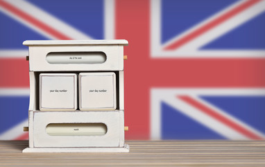 Fototapete - Wooden retro calendar with free space for a date on the background of the flag of Great Britain. Template for writing dates for United Kingdom national holidays with free text space