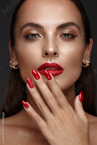 Fotografering Beautiful girl with a classic make-up and red nails
