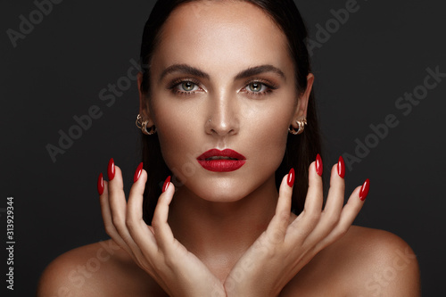 Fotografering Beautiful girl with a classic make-up and red nails