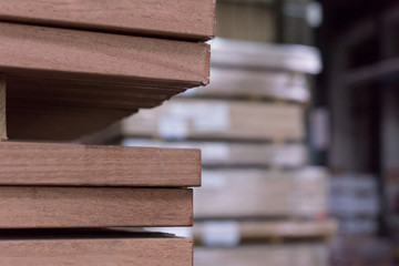 Wall Mural - Timber Flooring Factory. Pile of cut wood in factory storage warehouse. Lumber in warehouse.